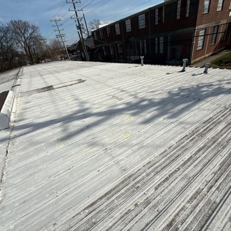 Metal commercial roof with hail impact dents