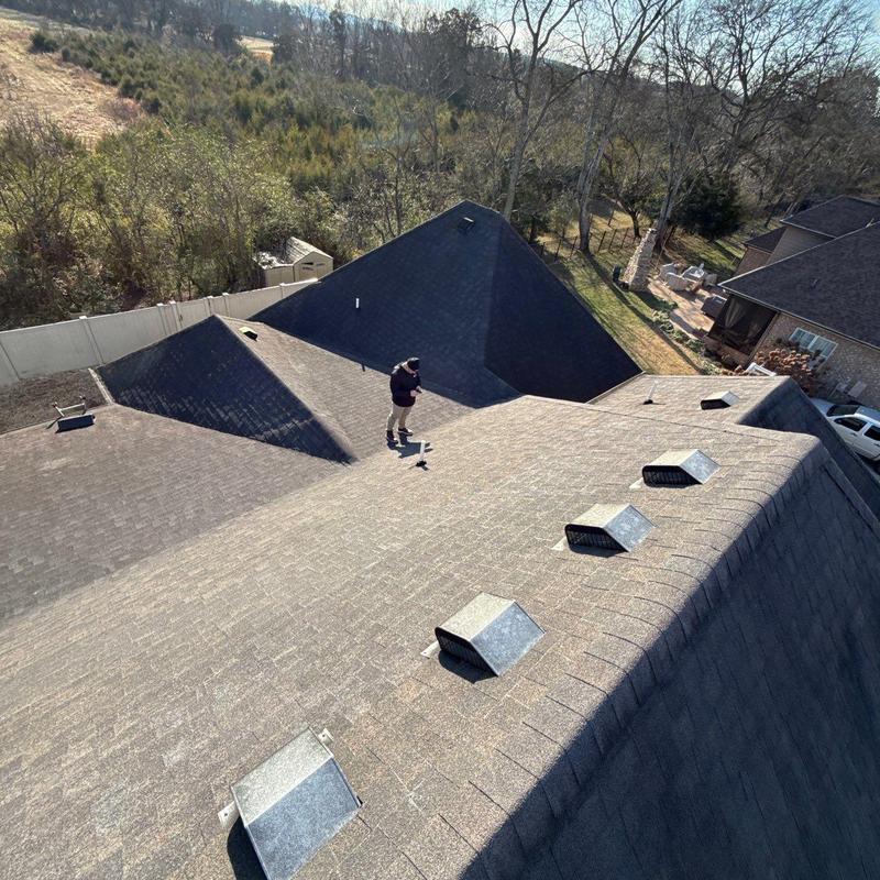 Asphalt shingle roof with vents during storm damage inspection