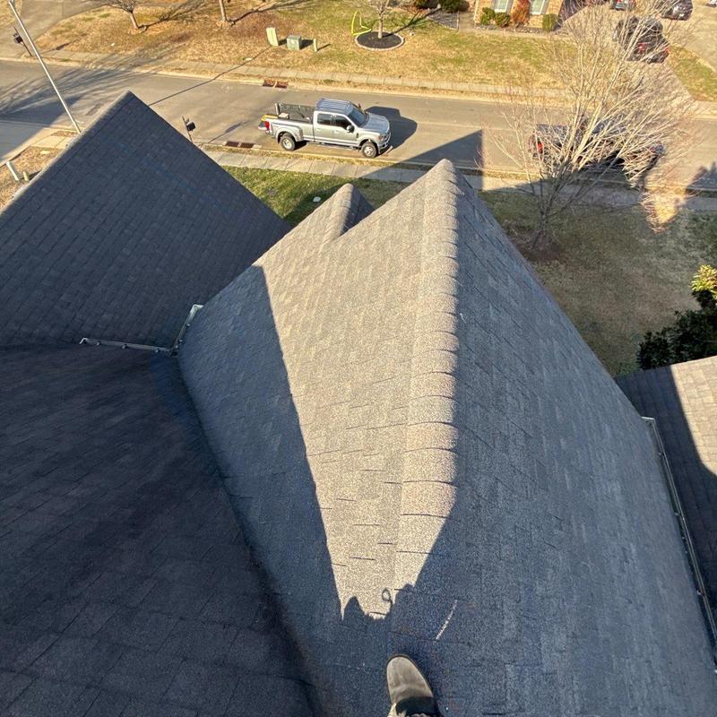 Asphalt shingle roof ridge inspection, aerial view
