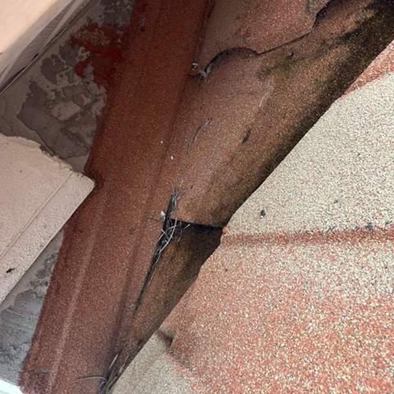 Stonecoated steel roof panels with visible damage