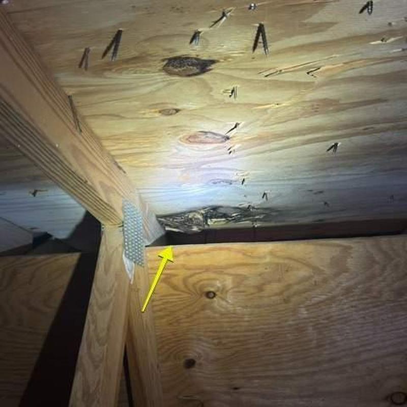 Rotted roof decking under stone-coated steel panels