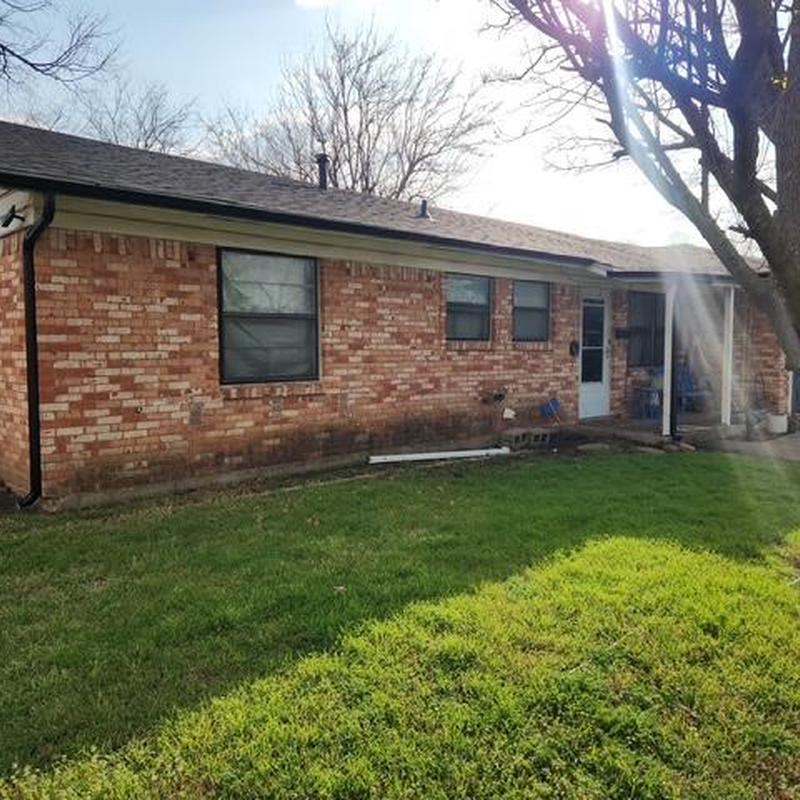 Gutter system on brick house exterior in sunlight