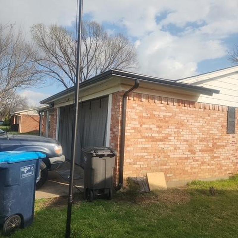 Gutter system on brick garage with downspout