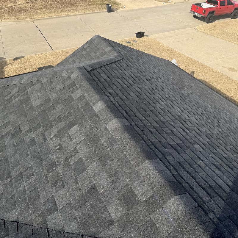 Black asphalt shingle roof with ridge caps in Mansfield TX