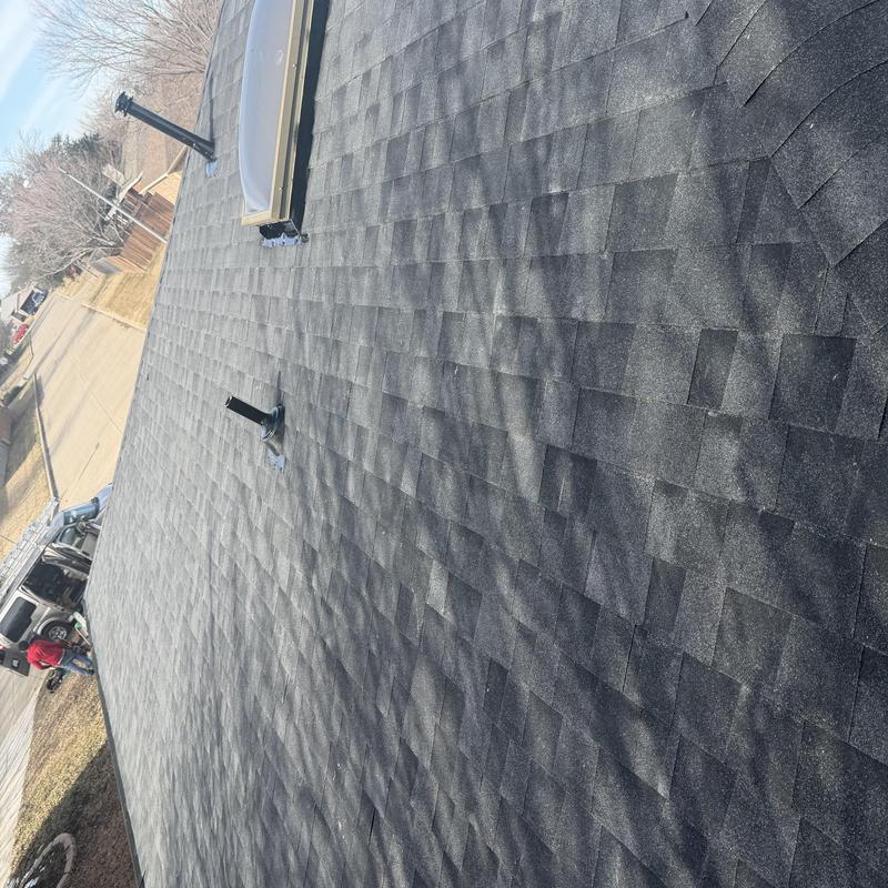 Asphalt shingle roof with vent pipes and skylight