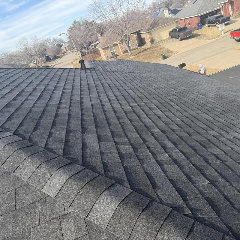 Asphalt shingle roof installation with dark gray color