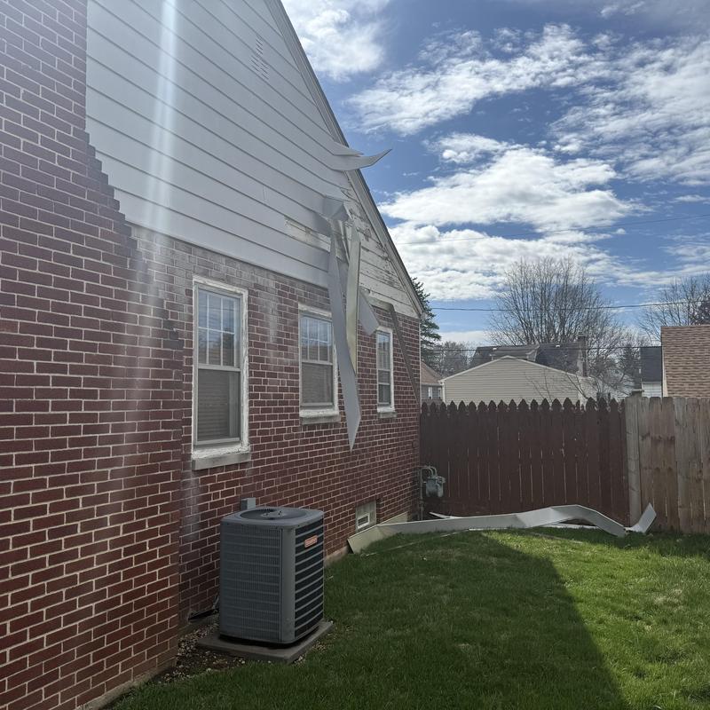 Aluminum siding damaged by windstorm on brick home Aluminum siding damaged by windstorm on brick home
