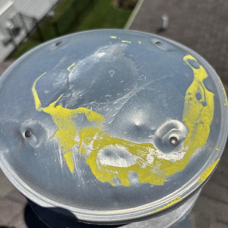 Metal roof vent cap with hail damage marks