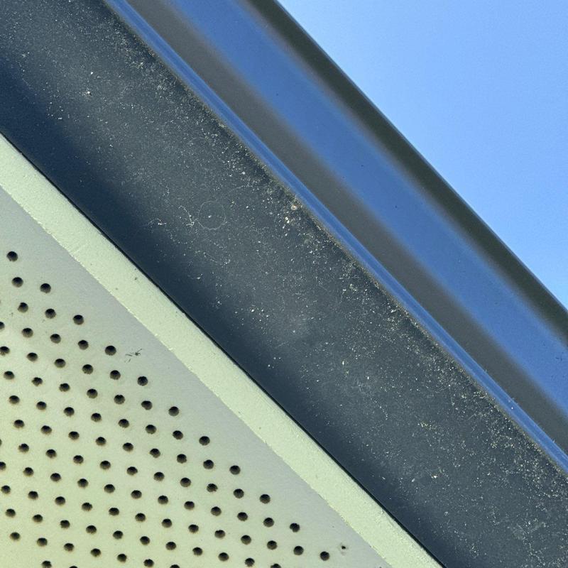 Ridge vent with minor hail damage on roof slope