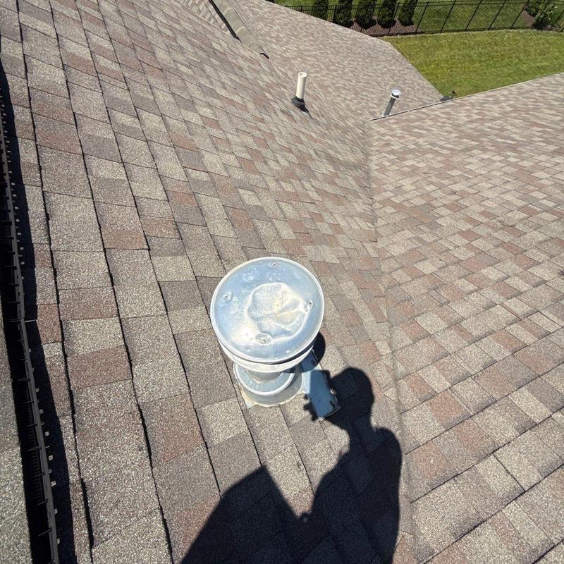 Asphalt shingle roof with hail damage and vent pipes