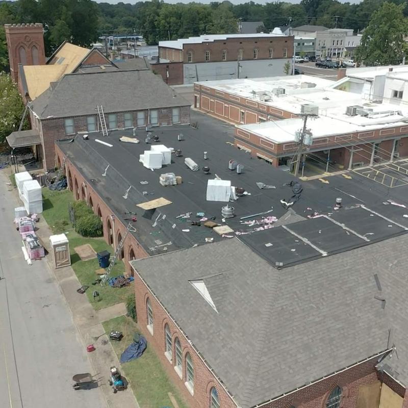 Flat commercial roof with new black membrane installation
