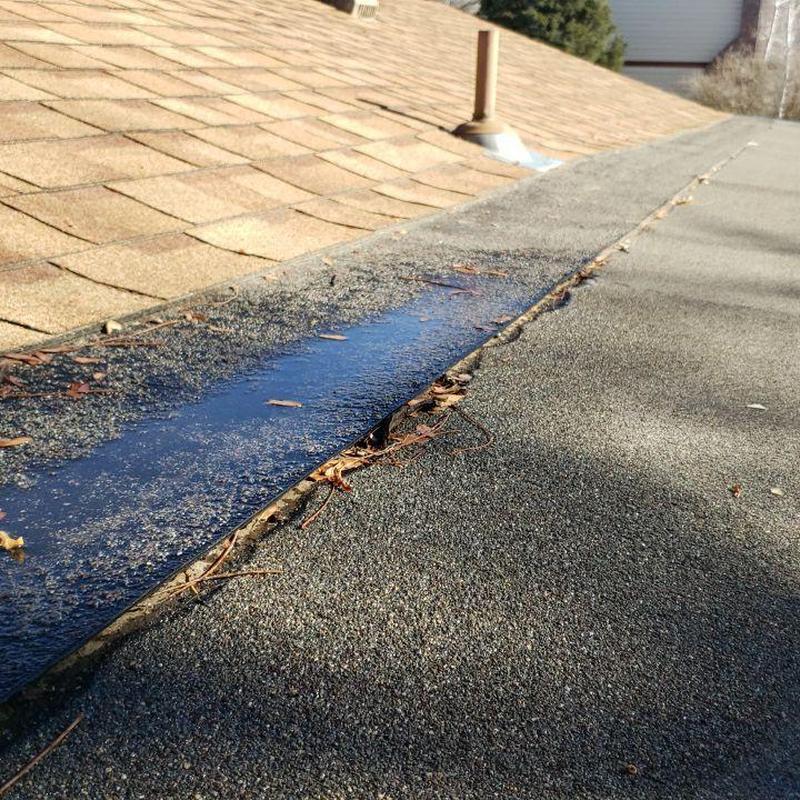 Modified flat roof with loose seams and debris Modified flat roof with loose seams and debris