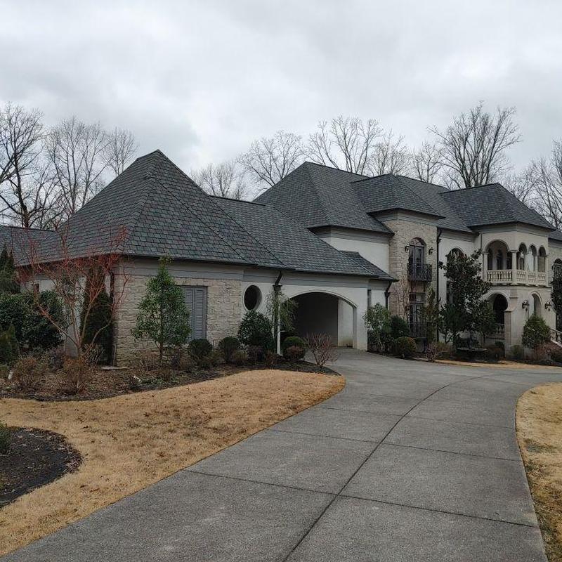 Asphalt designer shingle roof on luxury stone home