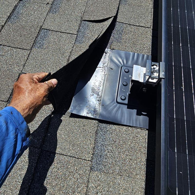Solar panel mounting flashing with loose roofing shingles