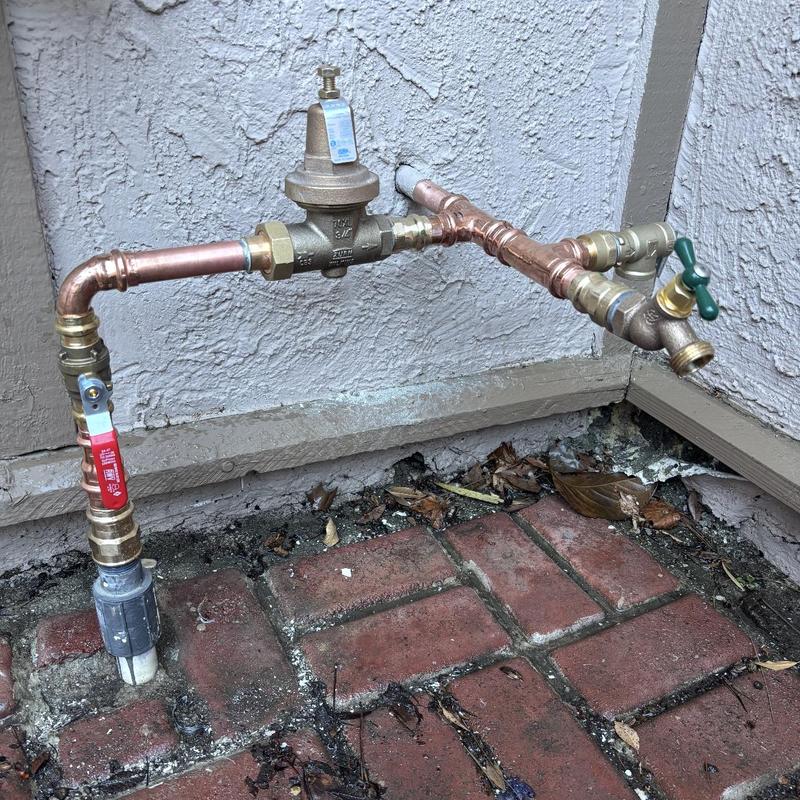 Pressure regulator and hose bib installation outdoors