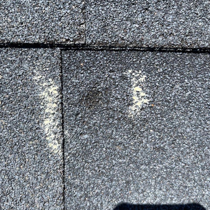 Asphalt shingle roof surface with hail damage marks