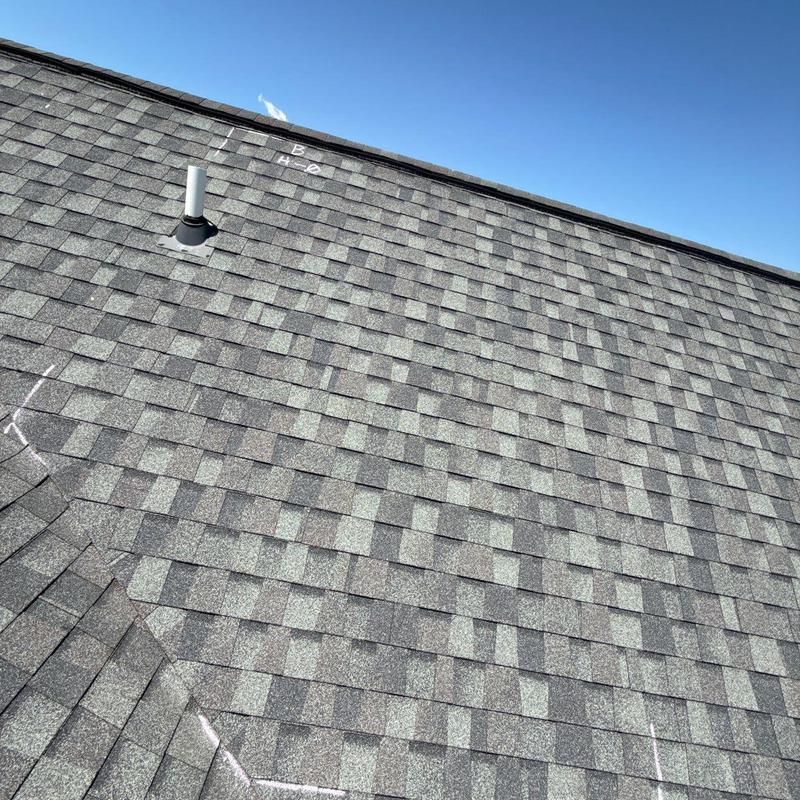 Asphalt shingle roof with hail damage inspection marks