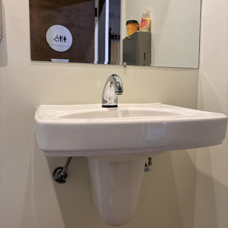 Basin faucet in warehouse bathroom with sensor sensor