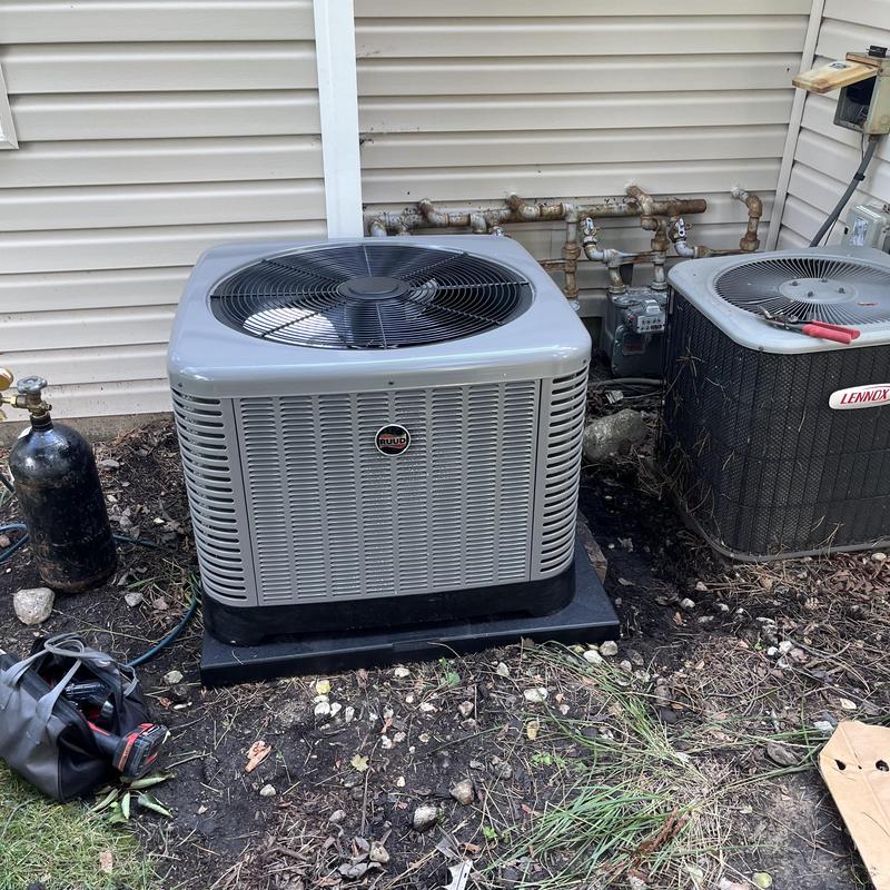 Ruud air conditioning condenser unit installed outside