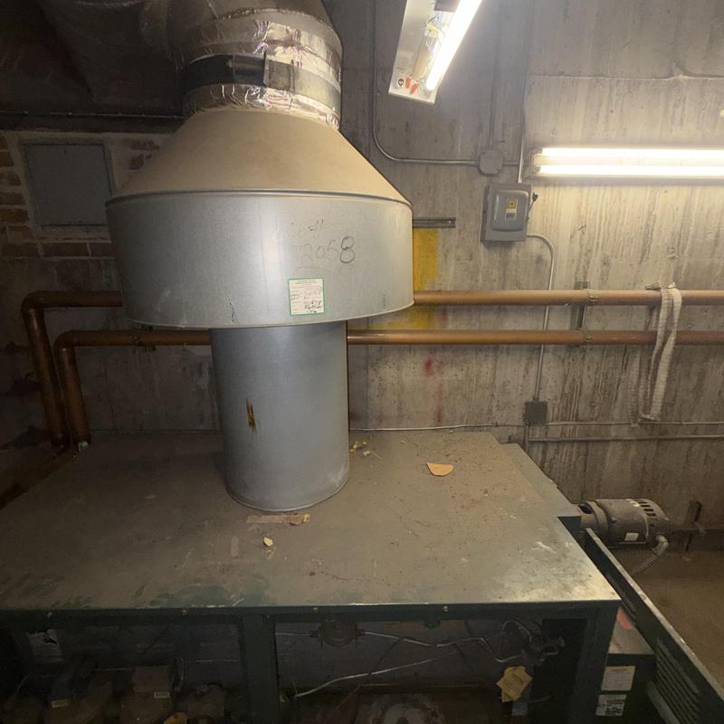 Boiler exhaust vent pipe with ductwork in basement