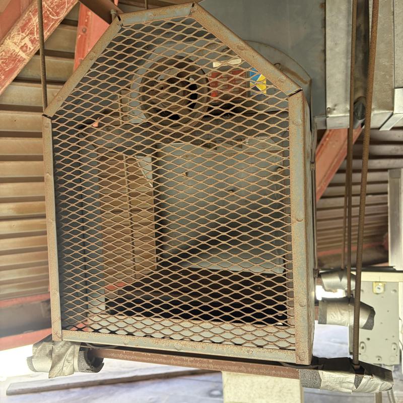 Industrial HVAC fan unit with protective metal mesh grille