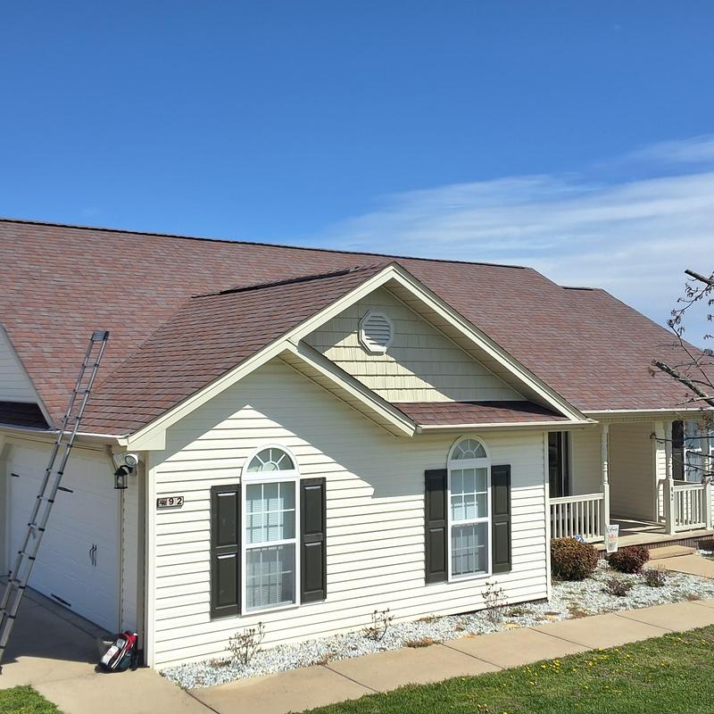 Asphalt shingle roof inspection with ladder and tools