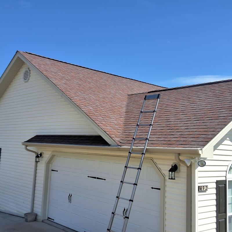 Asphalt shingle roof with ladder for hail damage inspection