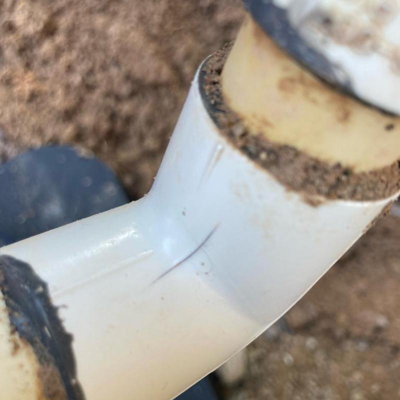 PVC irrigation water line with soil residue on fittings