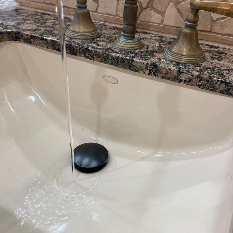 Bathroom sink drain stopper with running water