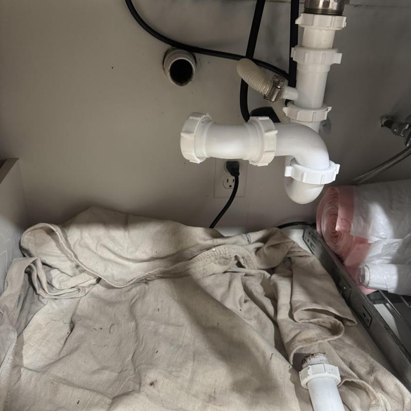 Kitchen sink drain pipes with hand snake cleaning setup