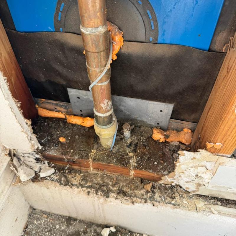 Copper water line with soldered fitting inside wall cavity