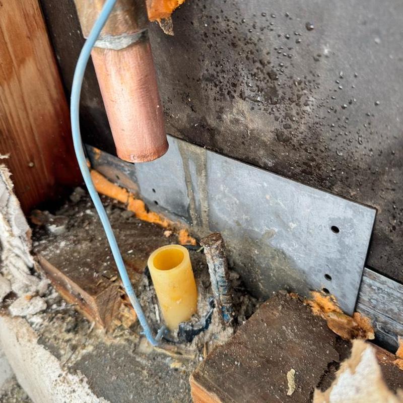 Copper water line with new PEX adapter inside wall cavity