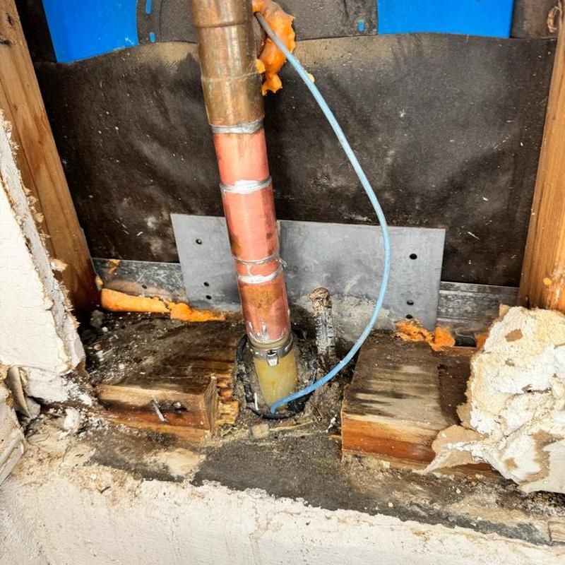 Copper water pipe with soldered and crimped connections inside wall