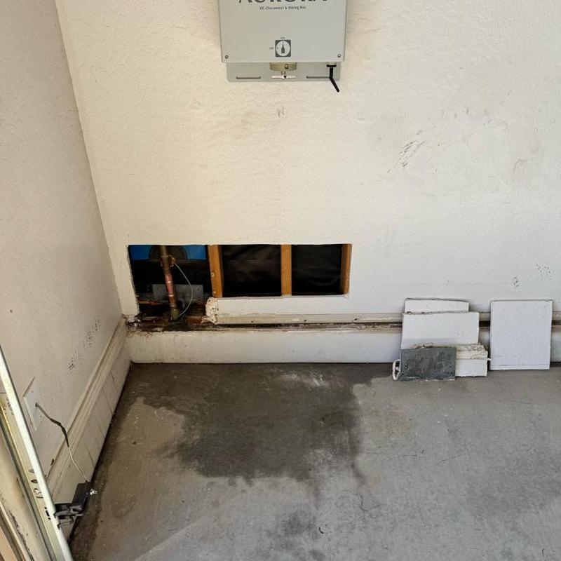 PEX water line with drywall cutout for leak repair