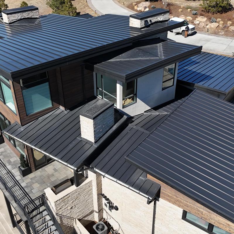 Standing seam metal roof with chimneys and snow fence Standing seam metal roof with chimneys and snow fence