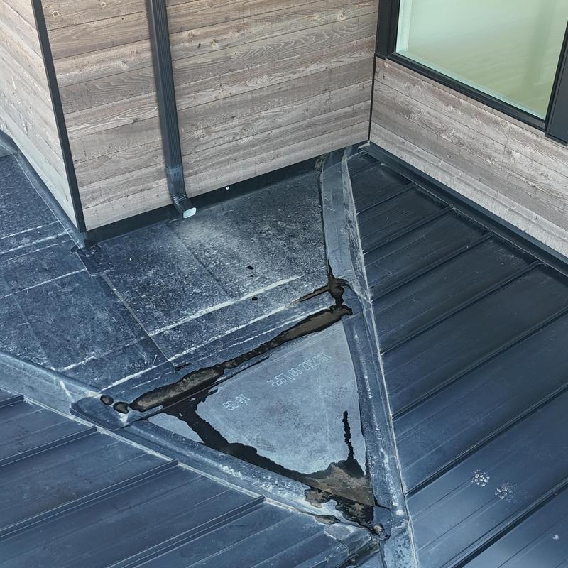 Standing seam metal roof with damaged flashing and sealant Standing seam metal roof with damaged flashing and sealant