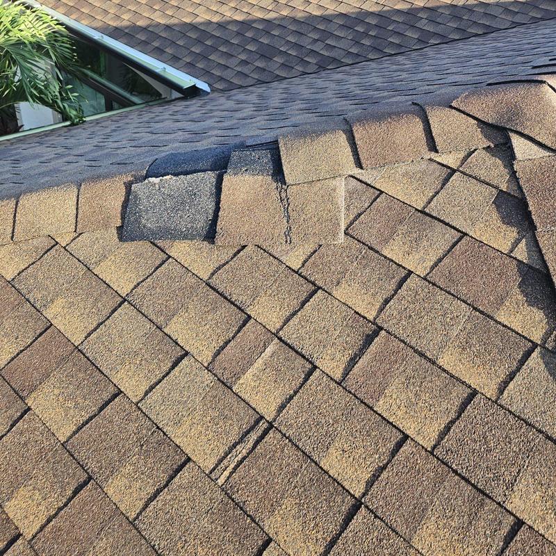 Shingle roof damaged area with missing shingles