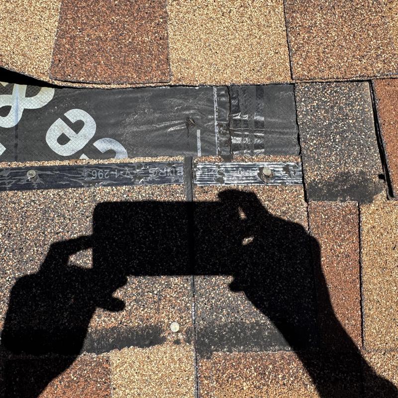 Asphalt shingle roof with exposed underlayment and nails Asphalt shingle roof with exposed underlayment and nails