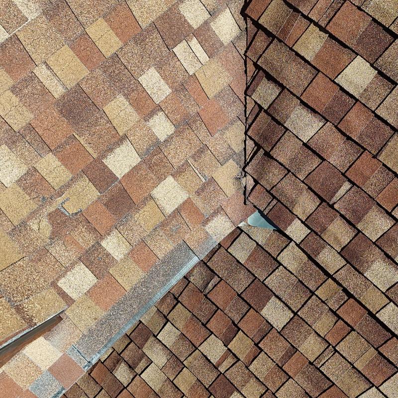 Asphalt shingle roof valley with metal flashing detail Asphalt shingle roof valley with metal flashing detail