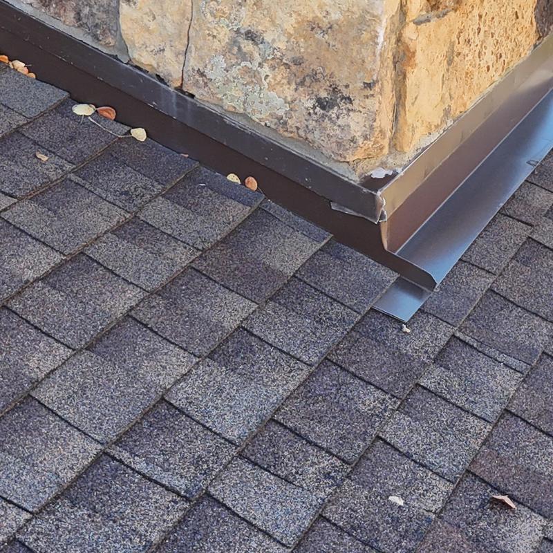 Asphalt shingle roof and chimney flashing detail Asphalt shingle roof and chimney flashing detail