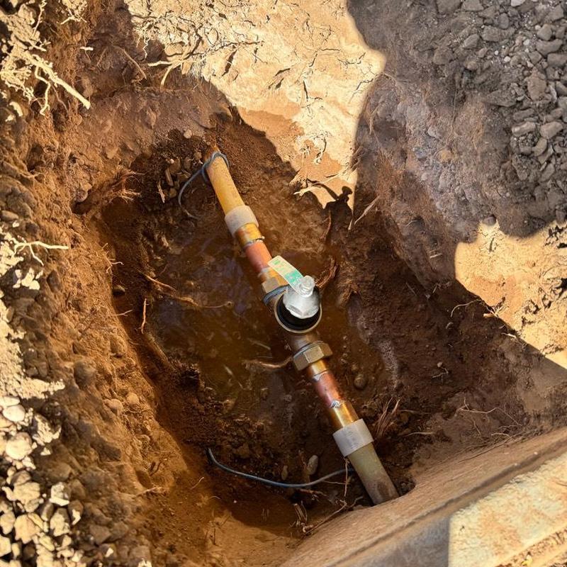 Pressure reducing valve installed underground in dirt trench
