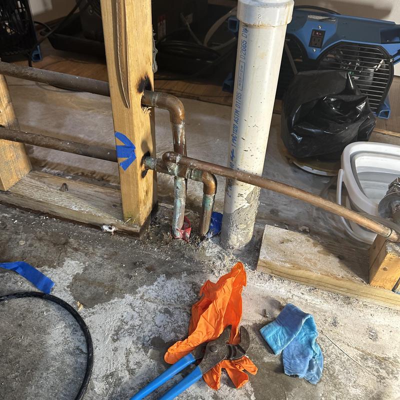 Copper plumbing pipe leaking repair with tools nearby