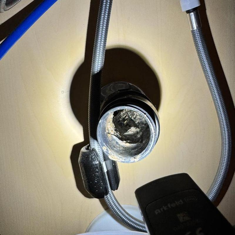 Kitchen sink drain pipe with buildup inside under cabinet Kitchen sink drain pipe with buildup inside under cabinet