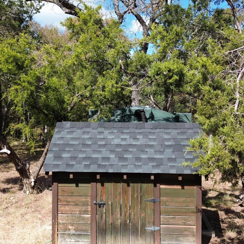 Asphalt shingle roof on wooden garden shed outdoors Asphalt shingle roof on wooden garden shed outdoors