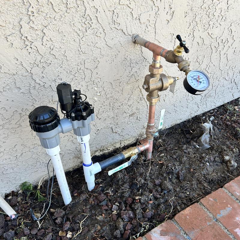 Copper water supply line with pressure valve and gauge