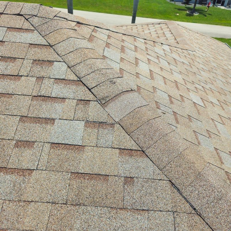 Asphalt shingle roof with repaired ridge and flashing