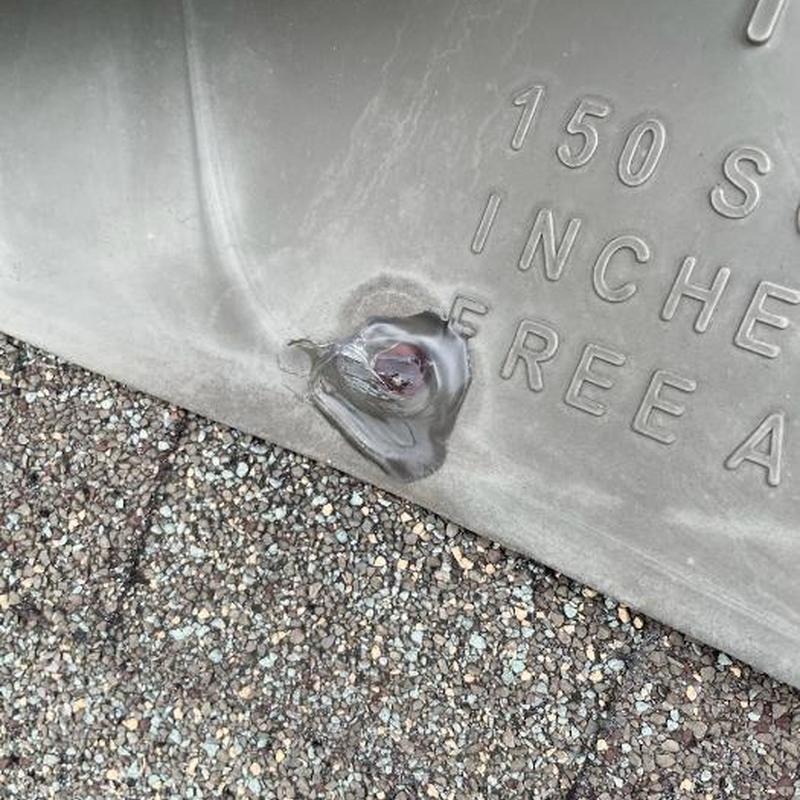 Roof flashing with sealed hole and gravel shingles