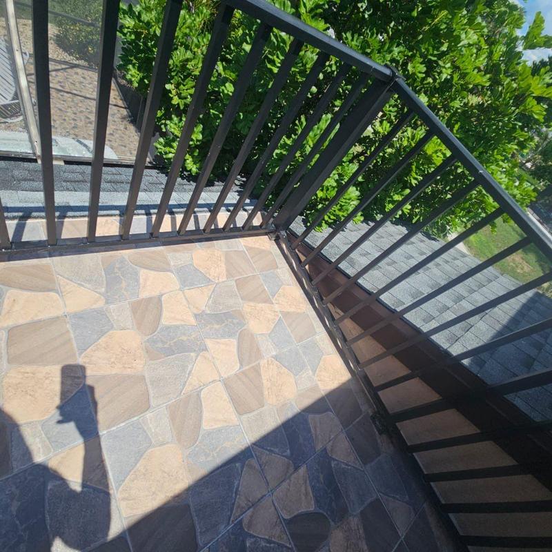 Shingle roof to flat deck transition with railing view