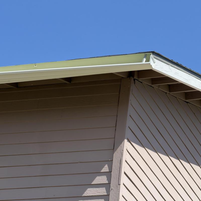 Gutter hanging from roof edge on retirement home