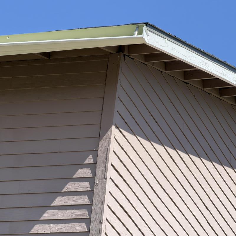 Gutter hanging from retirement home third floor roofline